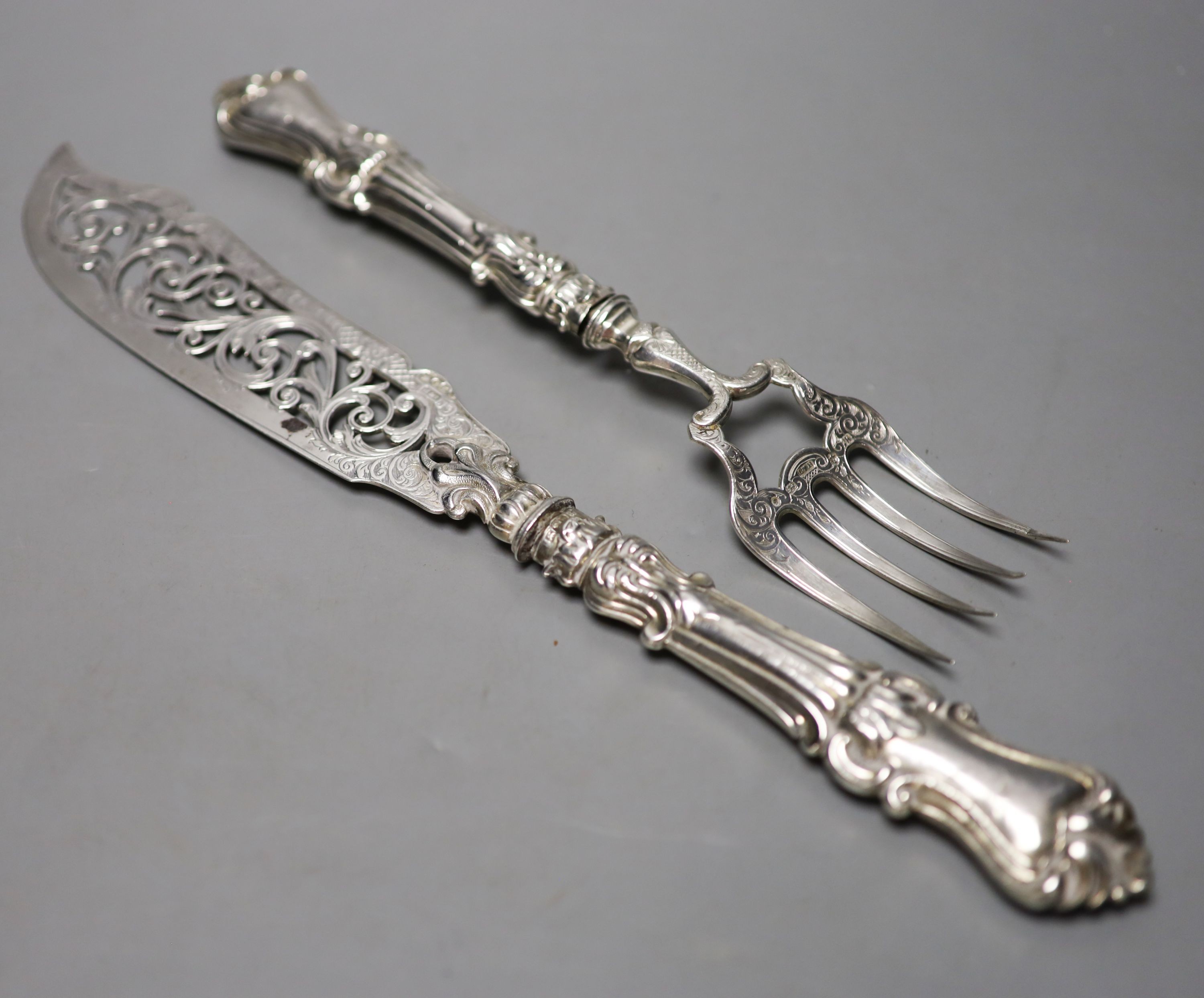 A pair of Victorian pierced silver fish servers, with loaded handles, Hilliard & Thomasson, Birmingham, 1859, knife 32cm.